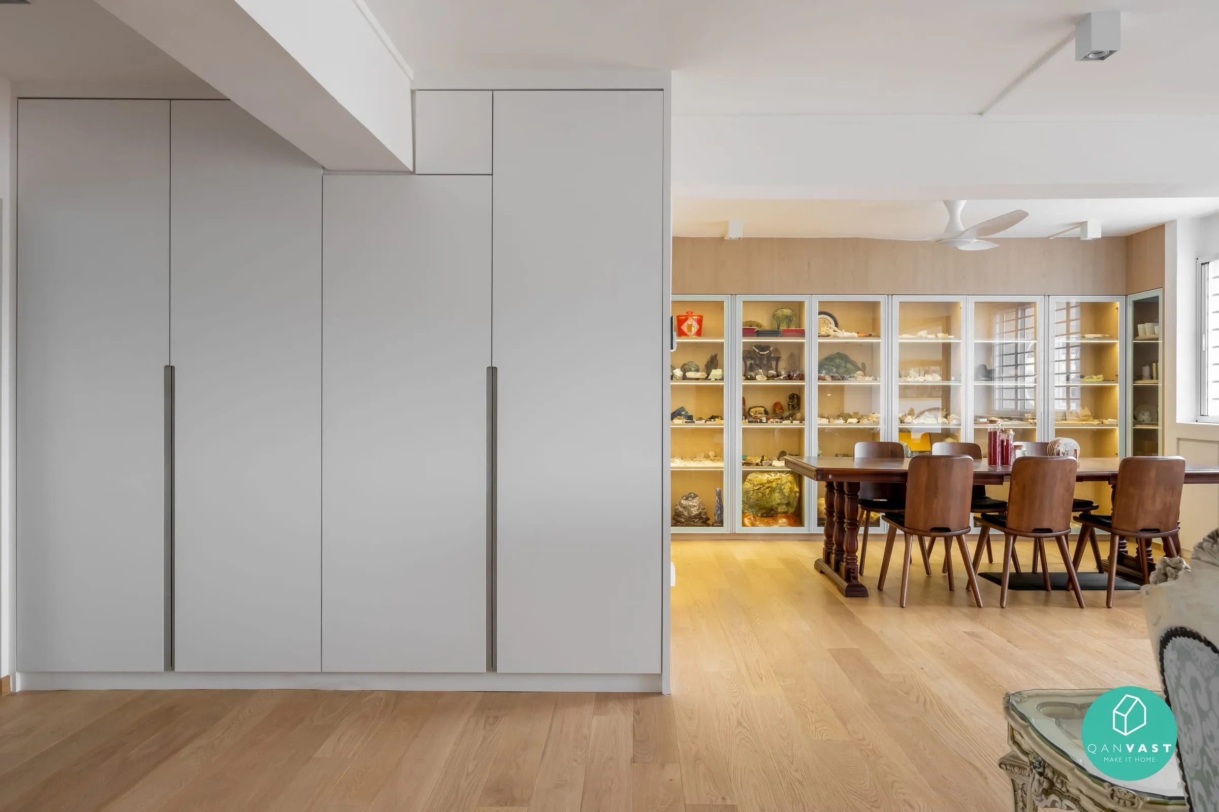 Living and dining room with full-height white joinery and timber floors